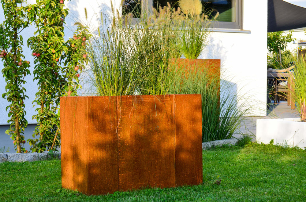 Hochbeet Monterosso 45x135x68 in Cortenstahl  im Garten vor Hauswand